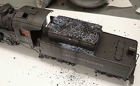 Gluing coal in place.